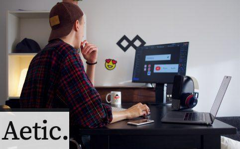 man sitting near table using computer