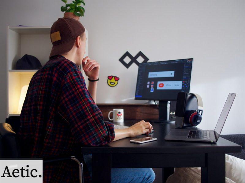 man sitting near table using computer