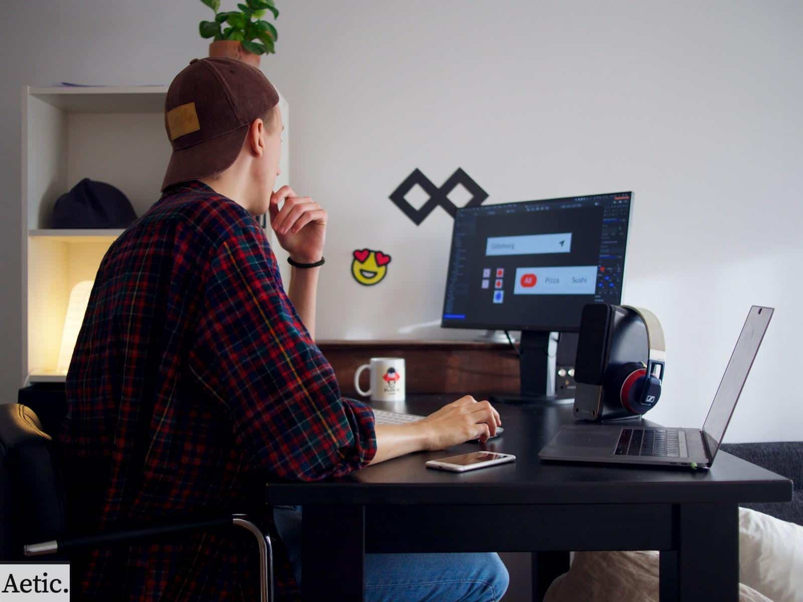 man sitting near table using computer
