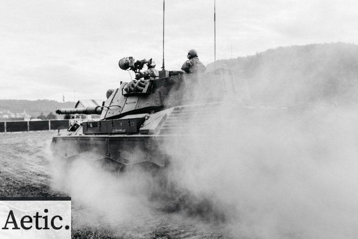 grayscale photo of soldiers on battle tank