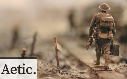 soldier walking on wooden pathway surrounded with barbwire selective focus photography