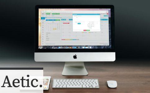 Silver Imac, Apple Magic Keyboard, and Magic Mouse on Wooden Table