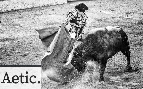 grayscale photo of matador and bull