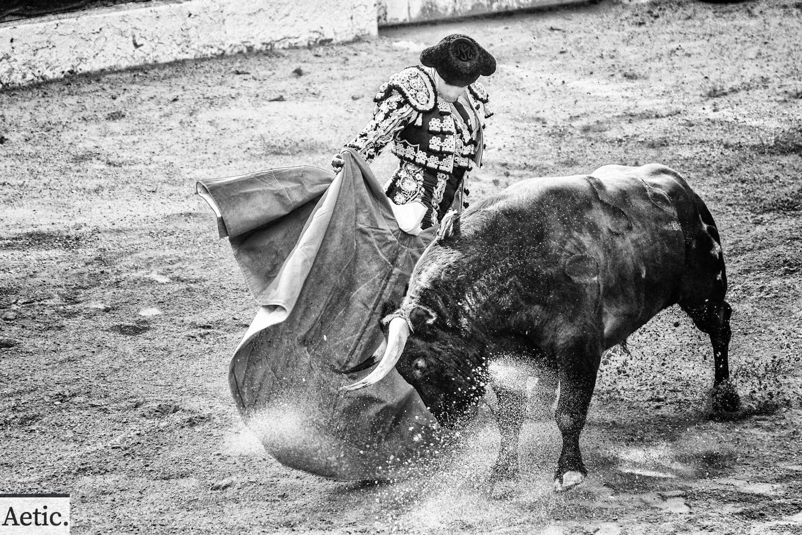 grayscale photo of matador and bull