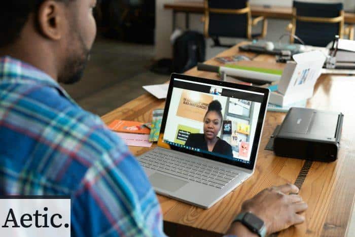 A Man in Blue Plaid Long Sleeves Using a Laptop
