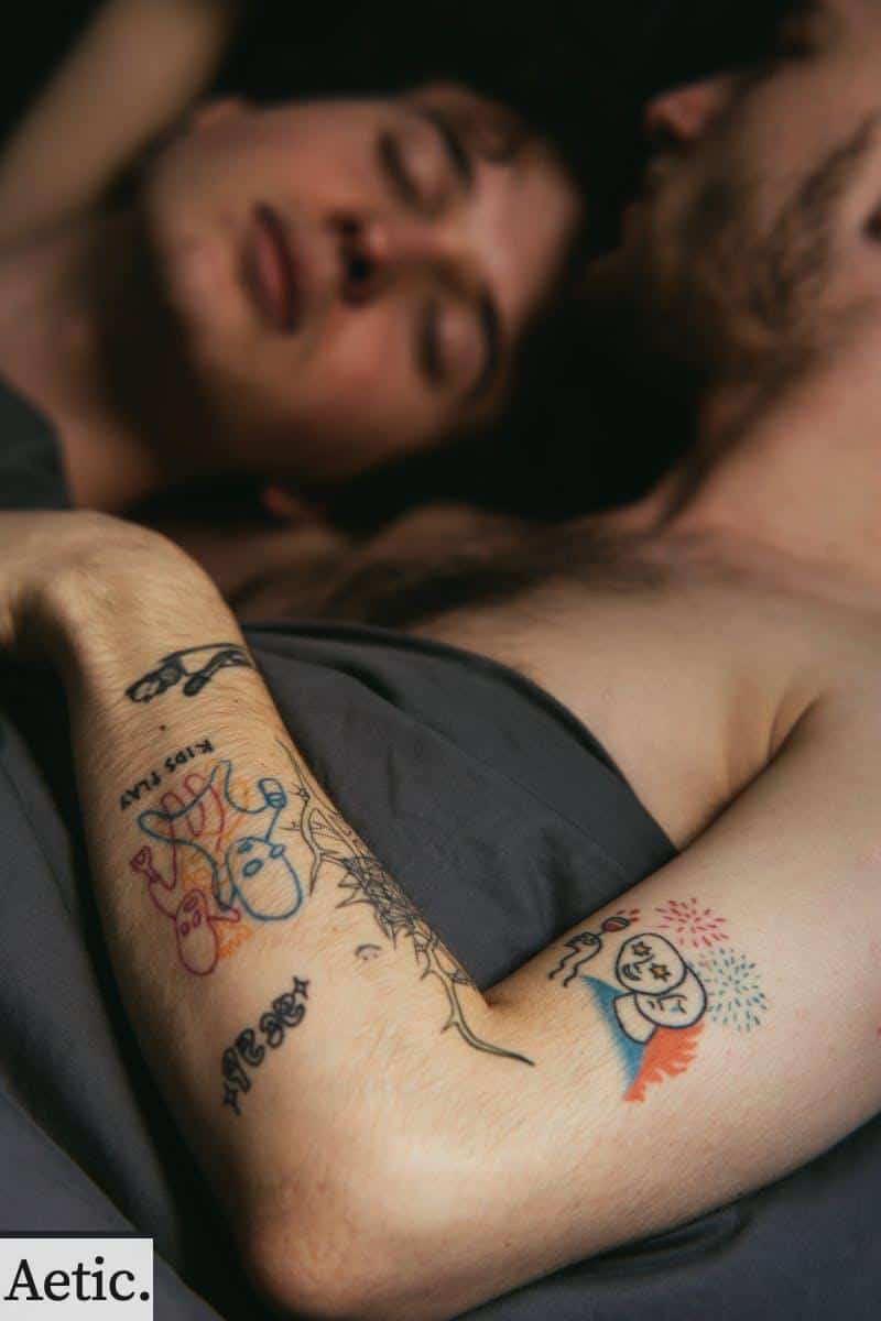 Tattooed Man Lying in Bed With Man