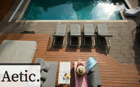 four gray loungers near pool