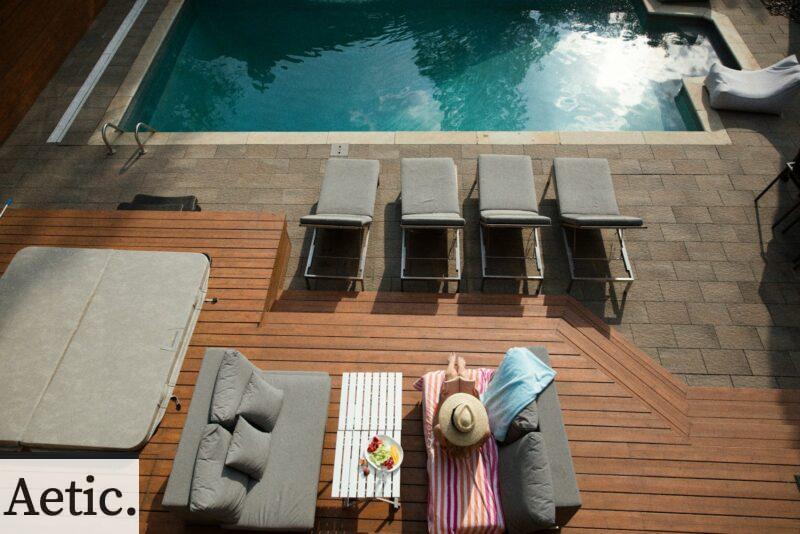four gray loungers near pool