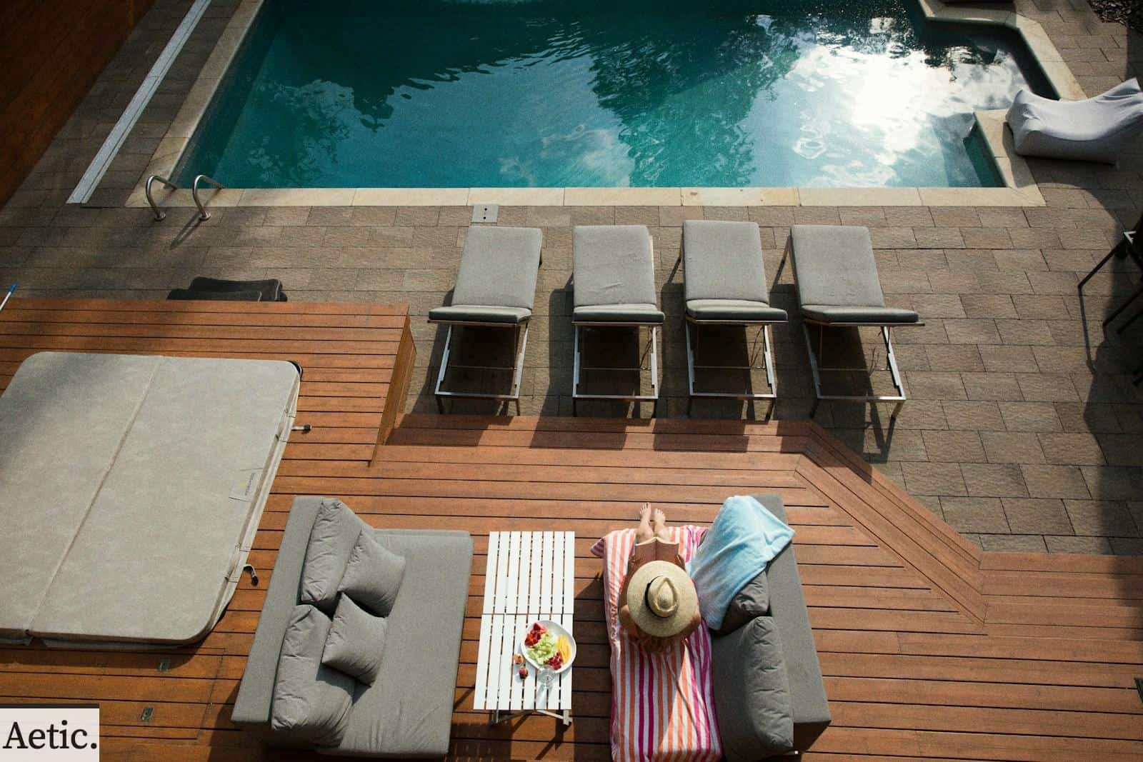 four gray loungers near pool