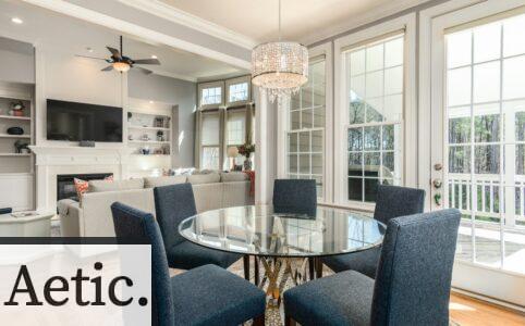 round clear glass-top table and five gray chairs dining se