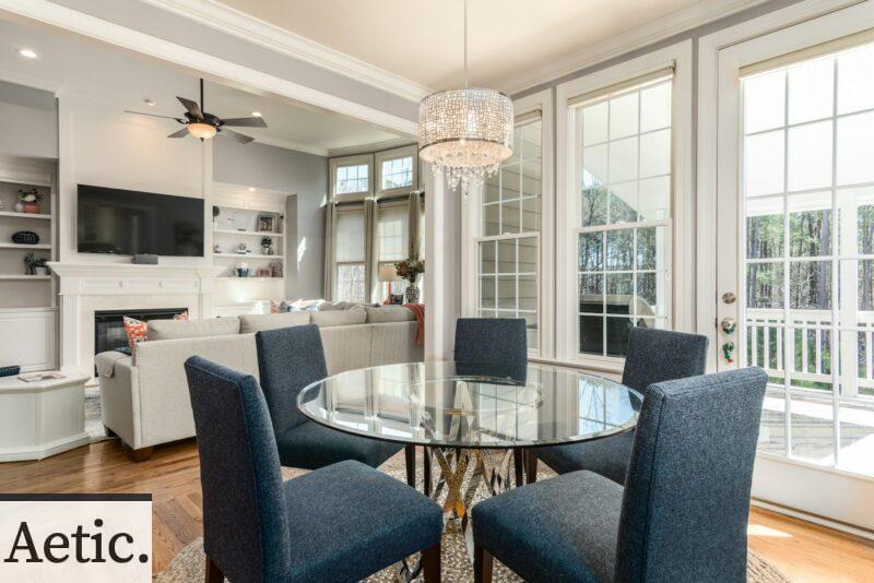 round clear glass-top table and five gray chairs dining se