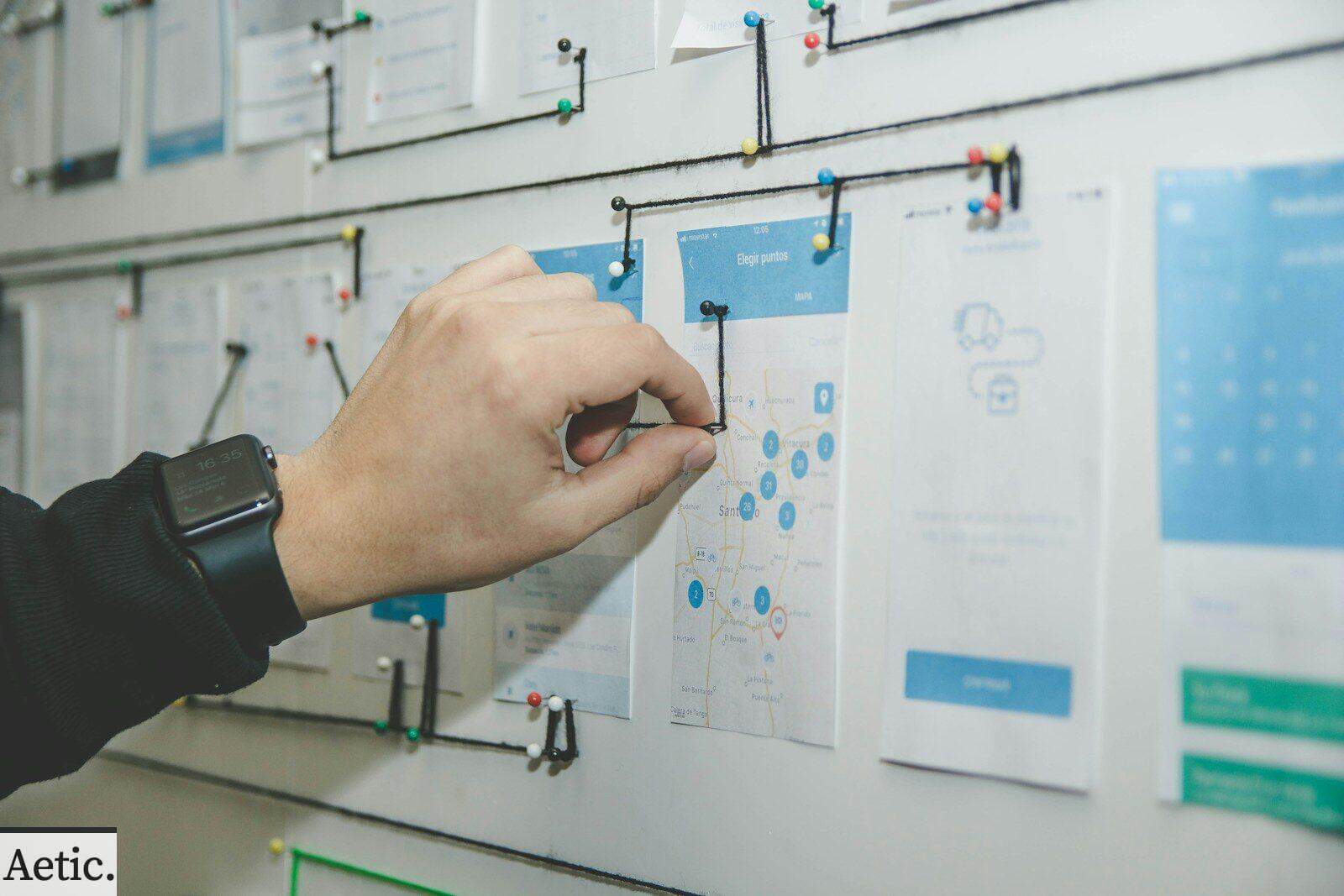person working on blue and white paper on board