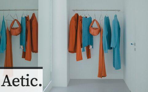 A room that has a bunch of clothes hanging on a rack