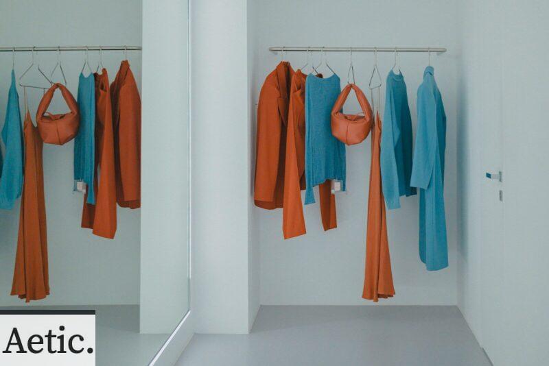 A room that has a bunch of clothes hanging on a rack