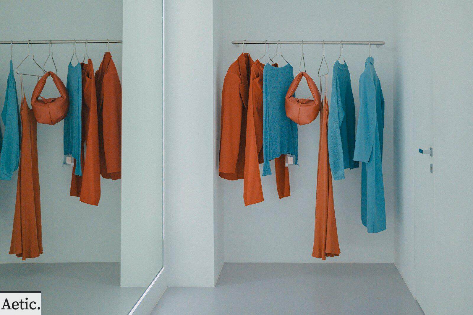 A room that has a bunch of clothes hanging on a rack