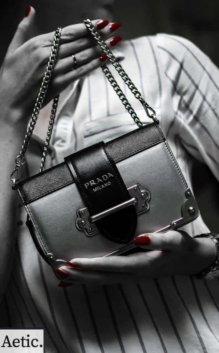 black leather handbag on white textile